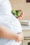 Pregnant female holding broccoli bowl
