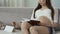 Pregnant female sitting with notebook and calendar counting days, pregnancy math