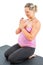 Pregnant fitness woman make stretch on yoga and pilates pose on white background