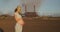 Pregnant girl on the background of an enterprise polluting the atmosphere. The concept of global pollution of the