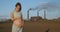Pregnant girl on the background of an enterprise polluting the atmosphere. The concept of global pollution of the