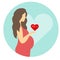 Pregnant girl with a belly in a red dress with a heart