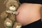 A pregnant girl clutches a Teddy bear to her stomach