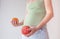Pregnant girl with fruits. The concept of bearing healthy offspring, replenishing vitamin deficiencies during pregnancy and