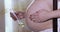 Pregnant girl lubricates the abdomen