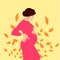 Pregnant girl. Pregnant woman in a pink dress. Expectant mother hugs her belly