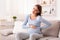 Pregnant Girl Suffering From Backache And Spasms Sitting On Couch