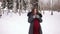 Pregnant girl walks in a winter and drinks hot tea