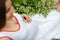 Pregnant girl in a white dress on a flower field with white daisies. Pregnancy concept