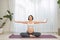 Pregnant happy fitness person enjoying yoga practice at home