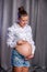 Pregnant happy woman touching her belly. Pregnant young mother portrait, caressing her belly and smiling. Healthy Pregnancy