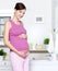 Pregnant happy woman touching stomach