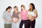 Pregnant, health and wellness with a group of woman friends expecting a baby in studio against a white background