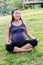 Pregnant healthy woman meditating in nature