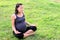 Pregnant healthy woman meditating in nature