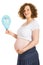 Pregnant holding blue balloon