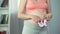 Pregnant lady expecting little girl, holding pink shoes near belly, baby shower