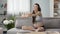 Pregnant lady sitting in headphones exercising, audio guide to pregnancy yoga