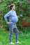 Pregnant man with big belly. Concept of male pregnancy. Happy expectation of baby. Joke