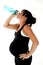 Pregnant model drinking water after her physical fitness workout