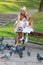 Pregnant mother and daughter feed pigeons