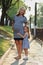 Pregnant mother and her little daughter stand in sunny par