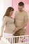 Pregnant mother and husband in baby\'s room