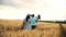 Pregnant mother with toy and basket walks to her family across the field