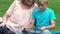 Pregnant mum playing game on tablet with son, happy motherhood, family planning