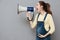 Pregnant screaming woman holding loudspeaker