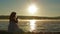 Pregnant Sits On The Lake In The Early Morning And Watch The Sunrise.