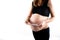 Pregnant skinny slim fit woman holding a positive pregnancy test on her belly tummy abdomen