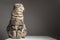 Pregnant thick gray striped scottish fold cat sitting on a table