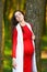 Pregnant in a white robe. Pregnant girl in a white coat walking in nature