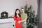 Pregnant wife and husband happy young family portrait in Christmas interior