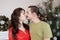 Pregnant wife and husband kissing each other, happy young family portrait in Christmas interior