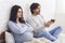 Pregnant woman angry to her husband playing video games with joystick
