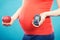 Pregnant woman with apple and glucose meter with good result sugar level, diabetes and nutrition during pregnancy