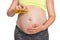 Pregnant woman is applying moisturizing body oil on belly