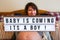 Pregnant woman and baby boy reveal sign