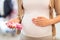 Pregnant woman with baby socks at clothing store