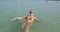 Pregnant woman bathing in salt water of Dead Sea. Resort in Israel