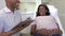 Pregnant Woman Being Given Ante Natal Check By Doctor