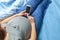 Pregnant woman with belly holds smartphone in hands.