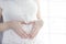 Pregnant woman belly, pregnancy heart shape, love sign