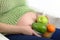 Pregnant woman with bowl of fruits and vegetables