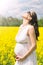Pregnant woman in canola field