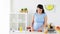 Pregnant woman chopping fruits at home kitchen