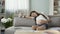 Pregnant woman closing laptop, leaning sideways on sofa to take a nap, tiredness