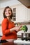 Pregnant woman cooking broccoli